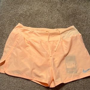 Neon orange NIKE athletic shorts